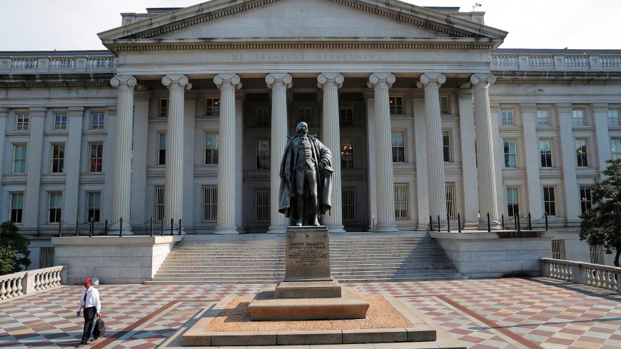 A man walks away from the U.S Treasury Department in Washington, U.S., August 6, 2018.     REUTERS/Brian Snyder - RC1FD03EA500