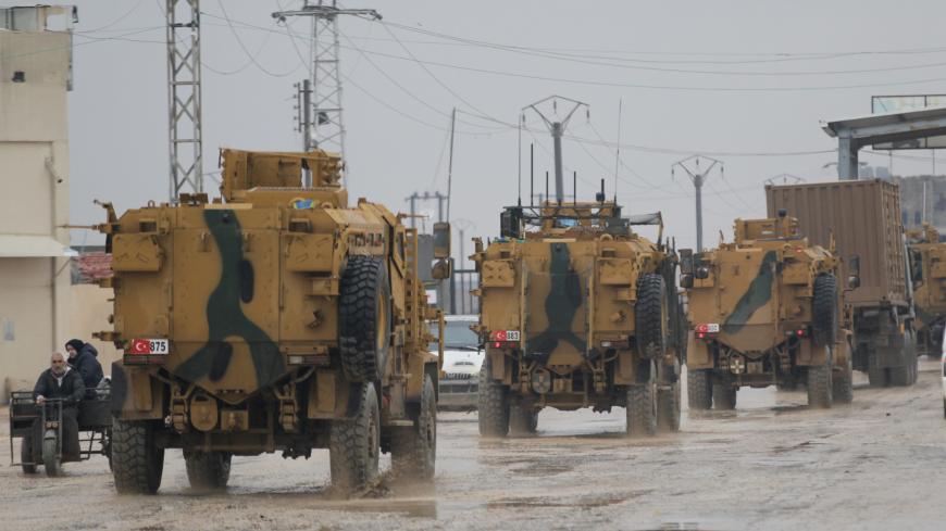 Turkish military vehicles ride at the Bab el-Salam border crossing between the Syrian town of Azaz and the Turkish town of Kilis, in Syria January 1, 2019. Picture taken January 1, 2019. REUTERS/Khalil Ashawi - RC1AD1B9E6A0