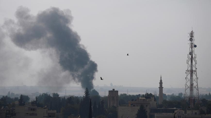 Smoke†rises†over the†Syrian†town†of†Ras†al-Ain, as seen†from†the Turkish†border†town†of Ceylanpinar, Sanliurfa province, Turkey, October 10, 2019.  REUTERS/Murad Sezer - RC155FC93160