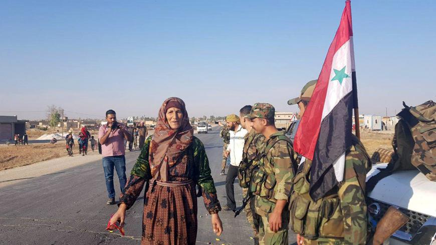 Syrian army soldiers are seen in the town of Tel Tamer in northeast Syria, in this handout released by SANA on October 14, 2019. SANA/Handout via REUTERS ATTENTION EDITORS - THIS IMAGE WAS PROVIDED BY A THIRD PARTY. REUTERS IS UNABLE TO INDEPENDENTLY VERIFY THIS IMAGE. - RC18459B82D0