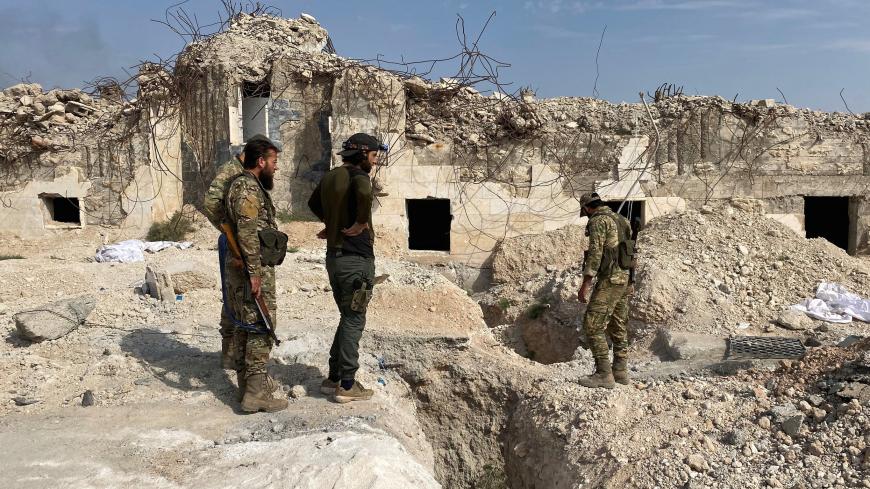 Turkey-backed Syrian rebel fighters stand near underground tunnels said to be made by the Syrian Democratic Forces (SDF) in Tal Abyad, Syria October 17, 2019. REUTERS/Mahmoud Hassano - RC174FE76C60