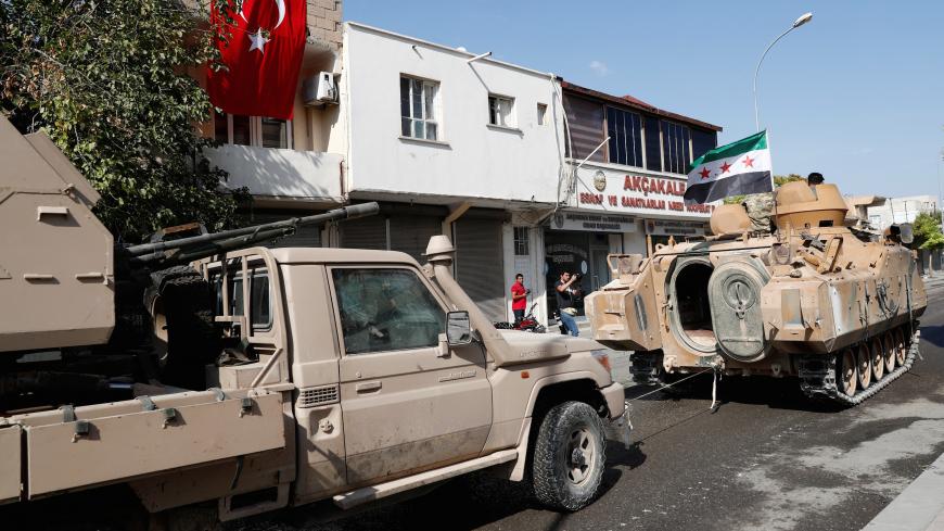 Turkey-backed Syrian rebel fighters return from the Syrian border town of Tal Abyad as they are pictured in Akcakale in Sanliurfa province, Turkey, October 18, 2019. REUTERS/Murad Sezer - RC1ED08DA570