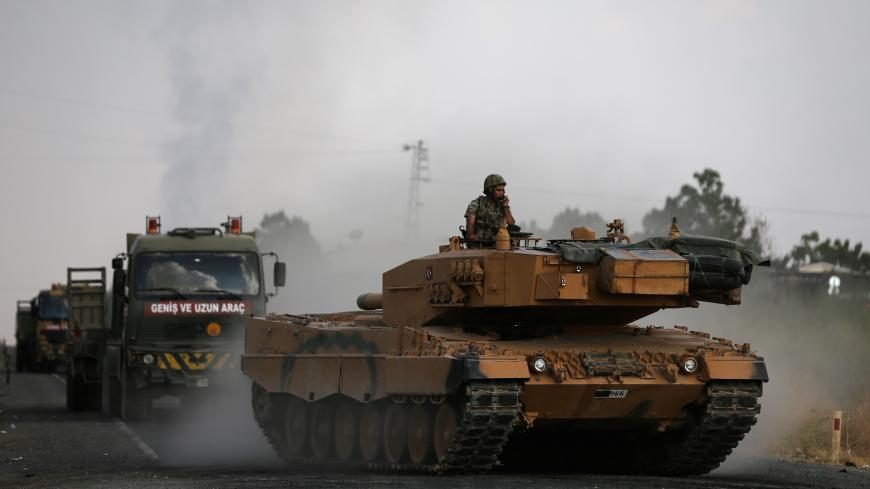 Turkish army vehicles are moving on a road near the Turkish border town of Ceylanpinar, Sanliurfa province, Turkey, October 18, 2019. REUTERS/Stoyan Nenov - RC1DD1CFA600