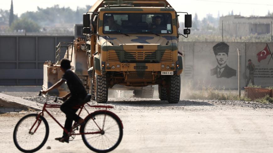 Turkish soldiers in a military vehicle return from the Syrian town of Tal Abyad, as they are pictured on the Turkish-Syrian border in Akcakale, Turkey, October 24, 2019. REUTERS/Huseyin Aldemir     TPX IMAGES OF THE DAY - RC1ED886E960