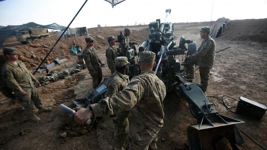 U.S. soldiers from the 2nd Brigade, 82nd Airborne Division clean the barrel of the artillery at a military base north of Mosul, Iraq, February 14, 2017. Picture taken February 14, 2017. REUTERS/Khalid al Mousily - RC16F437F890