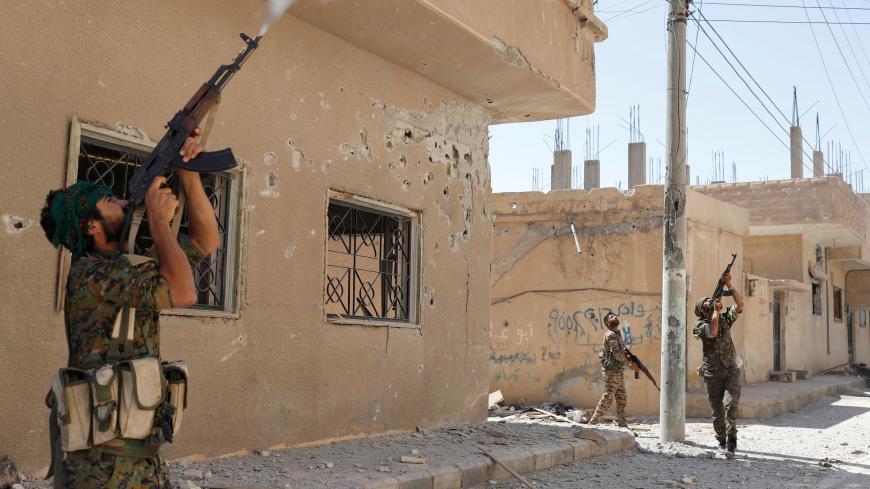Kurdish fighters from the People's Protection Units (YPG) fire rifles at a drone operated by Islamic State militants in Raqqa, Syria, June 16, 2017. Goran Tomasevic: "ISIS uses drones to monitor Kurdish fighters and drop bombs at their positions. On a few occasions I ran into a house with fighters because of drones. On one occasion a bomb from a drone landed near a house where I was hiding with the rest of our team and YPG fighters. The biggest challenge in Raqqa was very limited access and the heat. The te