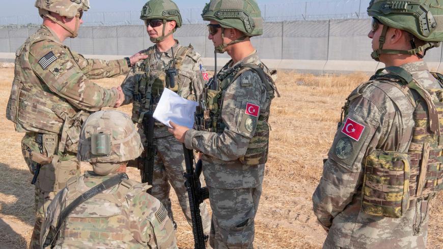 U.S. and Turkish military forces conduct a joint ground patrol inside the security mechanism area in northeast, Syria, October 4, 2019. Picture taken October 4, 2019.  U.S. Army/Staff Sgt. Andrew Goedl/Handout via REUTERS.  THIS IMAGE HAS BEEN SUPPLIED BY A THIRD PARTY. - RC11BB335F30