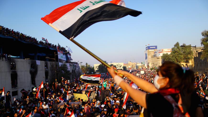 An Iraqi female demonstrator waves an Iraqi flag during an ongoing anti-government protest, in Baghdad, Iraq November 1, 2019. REUTERS/Ahmed Jadallah - RC164BCA0C20