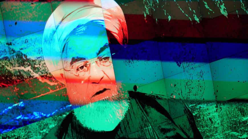 Iran's President Hassan Rouhani is shown on a large video screen as he addresses the 74th session of the United Nations General Assembly at U.N. headquarters in New York City, New York, U.S., September 25, 2019. REUTERS/Carlo Allegri - HP1EF9P16UTFU