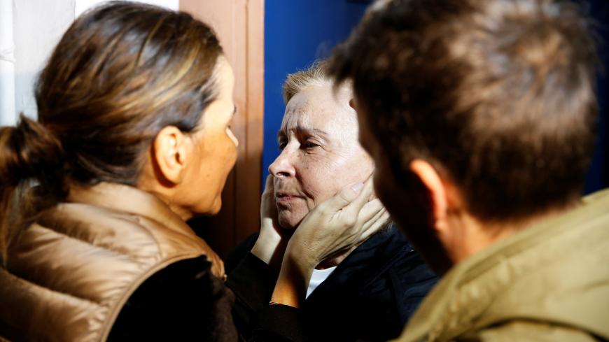 Journalist Nazli Ilicak, previously sentenced to life imprisonment for aiding the network of U.S.-based Muslim cleric Fethullah Gulen, accused by Ankara of orchestrating a coup attempt in 2016, is embraced by her relatives after being released from a prison in Istanbul, Turkey, November 4, 2019. REUTERS/Huseyin Aldemir - RC11B929AC90