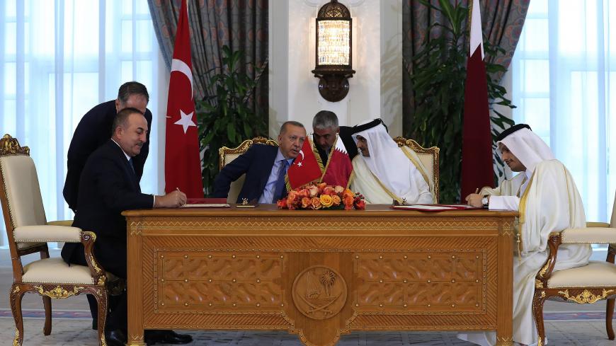 DOHA, QATAR - NOVEMBER 25: Turkeys Foreign Minister Mevlut Cavusoglu and Qatari counterpart Mohammed bin Abdulrahman Al-Thani take part in an agreement signing ceremony, held after inter-delegation working meal with Turkish President Recep Tayyip Erdogan and Emir of Qatar Tamim bin Hamad Al Thani in Doha, Qatar on November 25, 2019.

  (Photo by Mustafa Kamaci/Anadolu Agency via Getty Images)