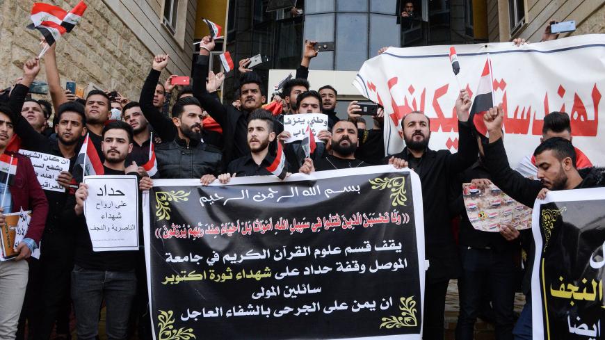 Students take part in a gather at the Mosul University to mourn protesters killed in anti-government rallies in the northern city of Mosul on December 1, 2019. - Demonstrators have hit the streets since early October in Baghdad and the Shiite-majority south to demand the ouster of a government they accuse of being corrupt, inefficient and beholden to foreign powers. After a spike in deaths this week raised the toll to more than 420 killed, Prime Minister Adel Abdel Mahdi said Friday he would submit his resi