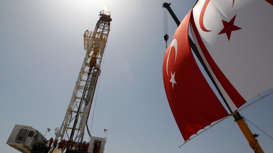 Turkish and Turkish Cypriot flags wave next to a drilling tower 25 km (16 miles) from Famagusta April 26, 2012. Turkish Cypriot Leader Dervis Eroglu and Turkey's Energy Minister Taner Yildiz attended a ceremony marking the start of joint gas and oil exploration works in northern Cyprus between Turkey's state-owned energy company TPAO and the Turkish-Cypriot administration. REUTERS/Umit Bektas (CYPRUS - Tags: POLITICS ENERGY BUSINESS) - GM1E84Q1HIQ01