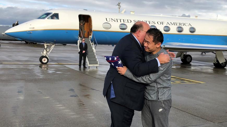 U.S. Ambassador to Switzerland Edward McMullen greets Xiyue Wang in Zurich, Switzerland December 7, 2019. U.S. Embassy in Switzerland/Handout via REUTERS ATTENTION EDITORS - THIS IMAGE WAS PROVIDED BY A THIRD PARTY - RC2GQD9FJJ4H