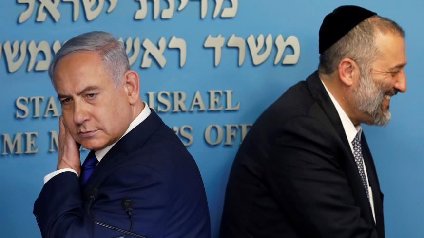 Israeli Prime Minister Benjamin Netanyahu and Israeli Interior Minister Aryeh Deri are seen at the end of a news conference at the Prime Minister's office in Jerusalem April 2, 2018. REUTERS/Ronen Zvulun - RC163EB70890