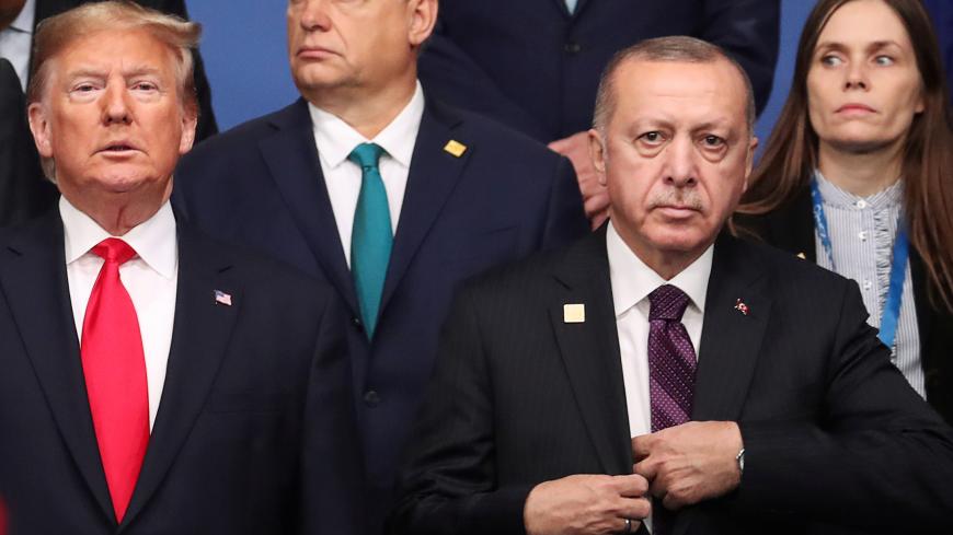 U.S. President Donald Trump and Turkey's President Recep Tayyip Erdogan pose for a family photo at the NATO leaders summit in Watford, Britain December 4, 2019. REUTERS/Yves Herman - RC2BOD97VB0U