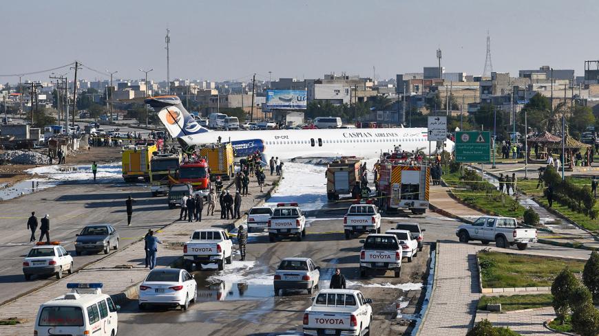 TOPSHOT - This picture taken on January 27, 2020 in Iran's southwestern city of Bandar-e Mahshahr shows a Caspian Airlines McDonnell Douglas MD-83 aircraft which landed on a highway after it overshot the highway during its approach. No casualties were reported according to state television. - The jet was flying from Tehran's Mehrabad Airport with 135 passengers plus the plane's crew. A state TV reporter travelling on the plane told the broadcaster that the aircraft's "back wheel had broken off, as we saw it