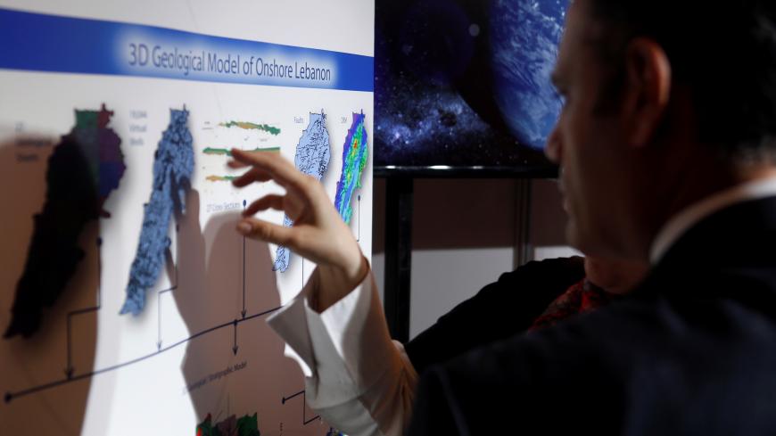 People inspect maps of Lebanon during the third Lebanon International Oil and Gas Summit in Beirut, Lebanon  May 9, 2017. REUTERS/ REUTERS/Mohamed Azakir - RC1AB4C7DE10