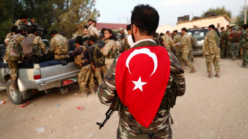 Turkey-backed Syrian rebel fighters pause before crossing into Syria, near the border town of Akcakale in Sanliurfa province, Turkey, October 17, 2019. REUTERS/Murad Sezer - RC129277BCC0