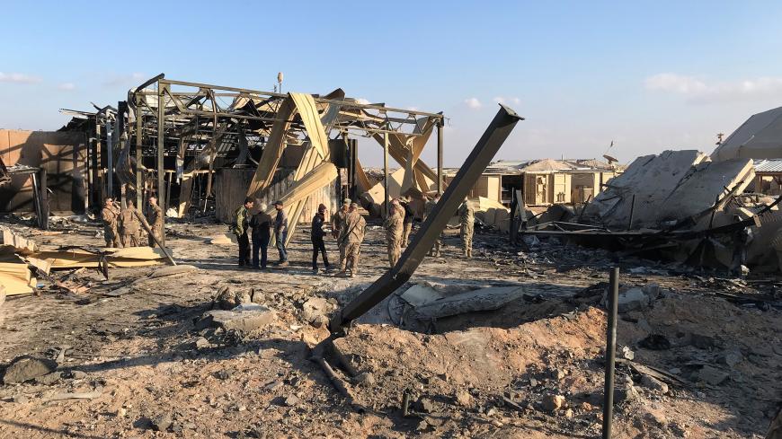 U.S. soldiers inspect the site where an Iranian missile hit at Ain al-Asad air base in Anbar province, Iraq January 13, 2020. REUTERS/John Davison - RC23FE9R37HE