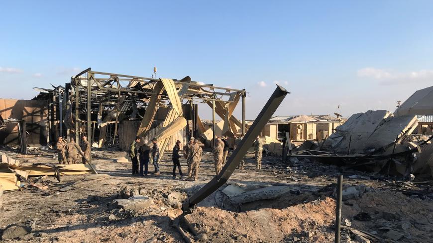 U.S. soldiers inspect the site where an Iranian missile hit at Ain al-Asad air base in Anbar province, Iraq January 13, 2020. REUTERS/John Davison - RC23FE9R37HE