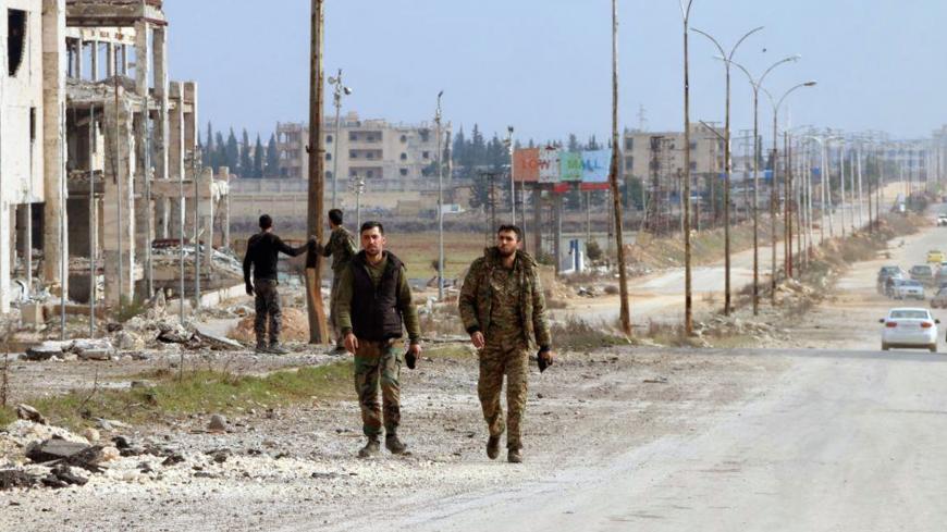 Syrian army soldiers walk along a street in Aleppo province, Syria, in this handout released by SANA on February 17, 2020. SANA/Handout via REUTERS ATTENTION EDITORS - THIS IMAGE WAS PROVIDED BY A THIRD PARTY. REUTERS IS UNABLE TO INDEPENDENTLY VERIFY THIS IMAGE - RC2K2F9QWRFR