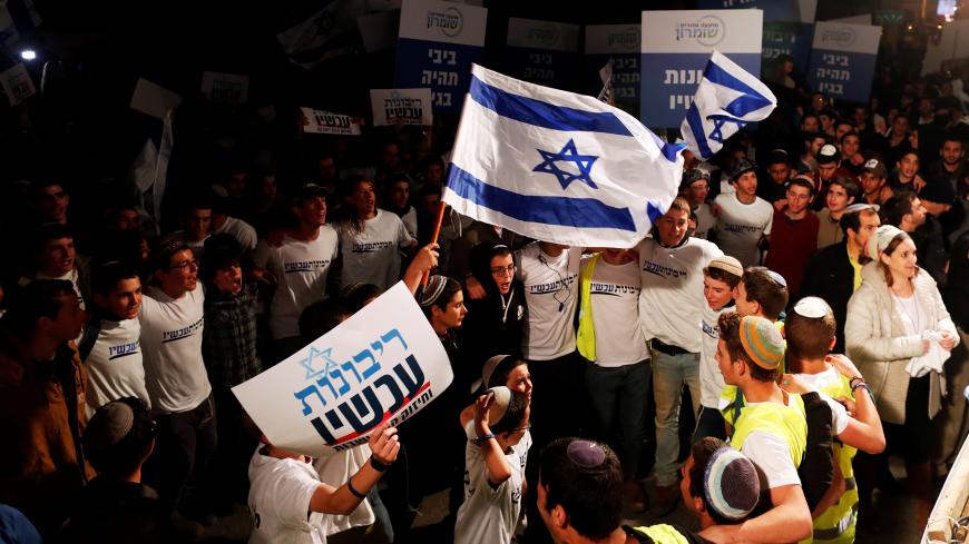 Israeli youth demonstrate as they call on Israeli Prime Minister Benjamin Netanyahu to declare sovereignty over Israel's settlements in the occupied West Bank, in Jerusalem February 13, 2020. The Hebrew writing reading, "Sovereignty Now". Picture taken February 13, 2020. REUTERS/Ronen Zvulun - RC2R7F9731YP