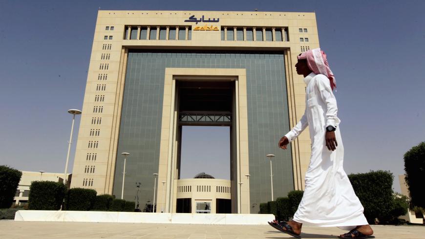 A man walks past the headquarters of Saudi Basic Industries Corp (SABIC) in Riyadh, Saudi Arabia October 27, 2013. REUTERS/Faisal Al Nasser/File Photo TPX IMAGES OF THE DAY - S1BETCCGREAA