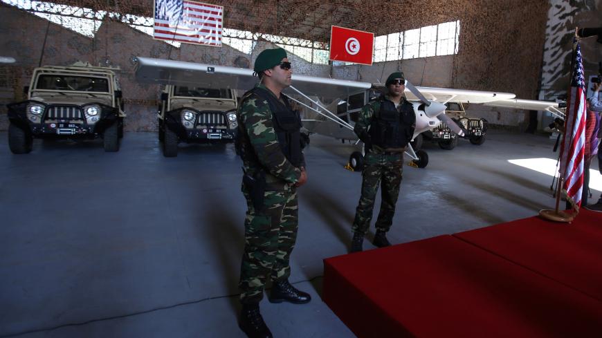 Tunisian soldiers stand in front of military equipment offered to Tunisia by the United States, in Tunis, Tunisia, May 12, 2016  REUTERS/Zoubeir Souissi - S1BETDRQOCAA