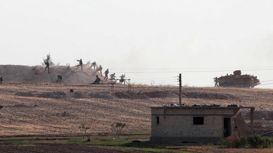 Turkey-backed Syrian rebel fighters are seen in action in the village of Yabisa, near the Turkish-Syrian border, Syria, October 13, 2019. REUTERS/Khalil Ashawi/File Photo SEARCH "GLOBAL POY" FOR THIS STORY. SEARCH "REUTERS POY" FOR ALL BEST OF 2019 PACKAGES. TPX IMAGES OF THE DAY. - RC2GOD9M52J9