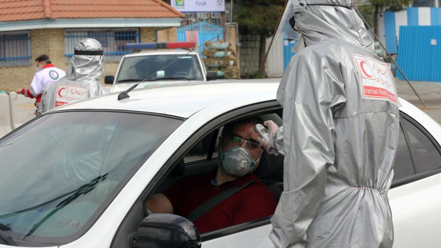 TEHRAN, IRAN - MARCH 26: Health officials check body temperature of drivers and passengers at the entrance of the capital Tehran as travel ban across the country was issued within the precaution against coronavirus (Covid-19) outbreak in Tehran, Iran on March 26, 2020. (Photo by Fatemeh Bahrami/Anadolu Agency via Getty Images)