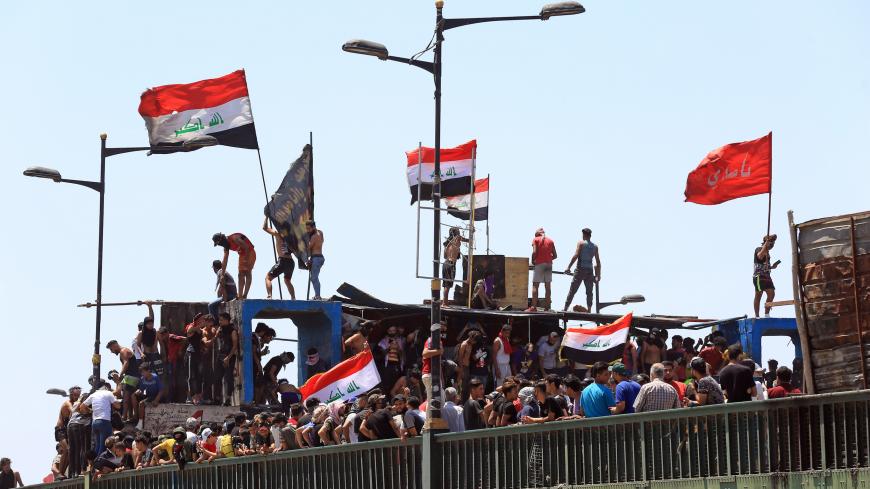 BAGHDAD, IRAQ - MAY 10: Iraqi security forces intervene Iraqi demonstrators with tear gas canisters and water cannons during a protest as the protests have started again after a break due to novel coronavirus (COVID-19) measures, at Tahrir Square in Baghdad, Iraq on May 10, 2020. (Photo by Murtadha Al-Sudani/Anadolu Agency via Getty Images)