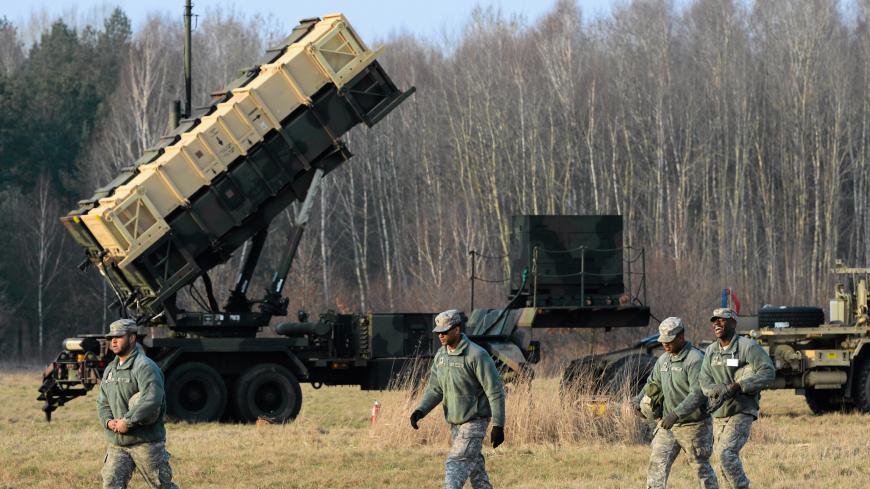 U.S soldiers walk next to a Patriot missile defence battery during join exercises at the military grouds in Sochaczew, near Warsaw, March 21, 2015. The U.S. Army Europe has deployed a Patriot missile defence battery as part of joint exercises with Poland aimed at reassuring the NATO member in light of the conflict in neighbouring Ukraine. Picture taken March 21, 2015. REUTERS/Franciszek Mazur/Agencja Gazeta THIS IMAGE HAS BEEN SUPPLIED BY A THIRD PARTY. IT IS DISTRIBUTED, EXACTLY AS RECEIVED BY REUTERS,