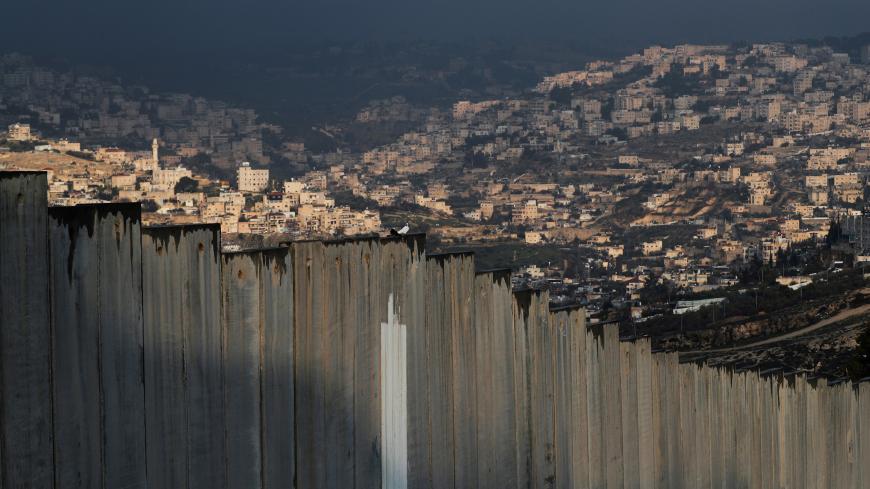 A general view picture shows part of East Jerusalem neighbourhoods behind the Israeli barrier January 29, 2020. REUTERS/Ammar Awad - RC2LPE9PKBS0