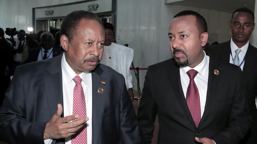 Sudan's Prime Minister Abdalla Hamdok and Ethiopia's Prime Minister Abiy Ahmed arrive for the opening of the 33rd Ordinary Session of the Assembly of the Heads of State and the Government of the African Union (AU) in Addis Ababa, Ethiopia, February 9, 2020. REUTERS/Tiksa Negeri - RC21XE9C5IAK