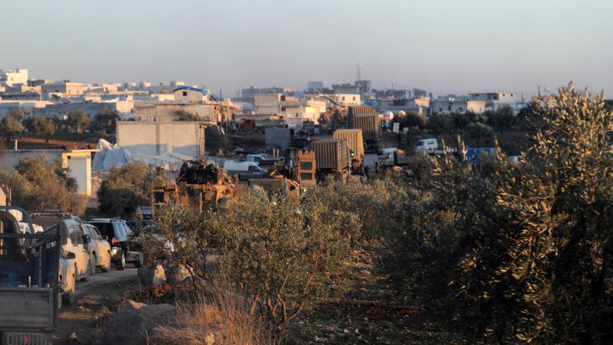 Turkish military vehicles enter the Bab al-Hawa crossing at the Syrian-Turkish border, in Idlib governorate, Syria, February 9, 2020. REUTERS/Khalil Ashawi - RC2AXE9GPS00
