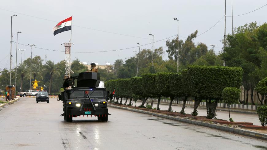 Iraqi security forces patrol a street, during a curfew imposed to prevent the spread of coronavirus disease (COVID-19), in Baghdad, Iraq March 18, 2020. REUTERS/Thaier Al-Sudani - RC2CMF94NO5Z