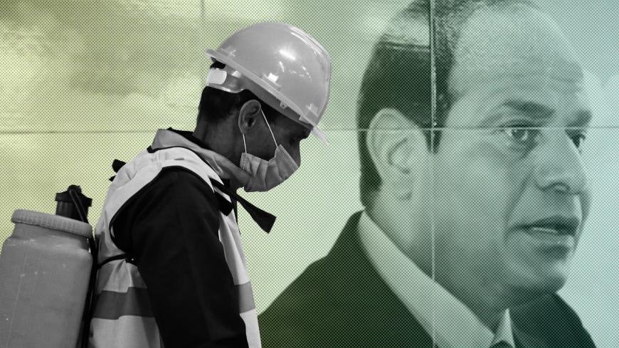 A member of medical team is seen beside a banner for the Egyptian President Abdel Fattah el-Sisi, as he sprays disinfectant as a precautionary move amid concerns over the coronavirus disease (COVID-19) outbreak at the underground Al Shohadaa "Martyrs" metro station in Cairo, Egypt March 22, 2020. REUTERS/Mohamed Abd El Ghany - RC23PF95EE3P