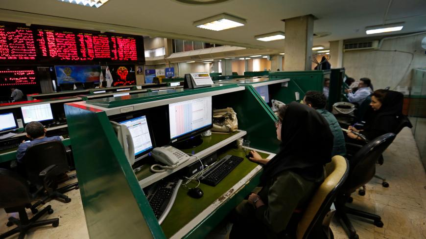 Iranian dealers monitor the stock market at the stock exchange in the capital Tehran on May 8, 2018. - Renewed nuclear sanctions would certainly cause severe problems for Iran's economy, but much of the damage has already been done by the uncertainty created by the US and myriad home-grown problems. (Photo by ATTA KENARE / AFP)        (Photo credit should read ATTA KENARE/AFP via Getty Images)
