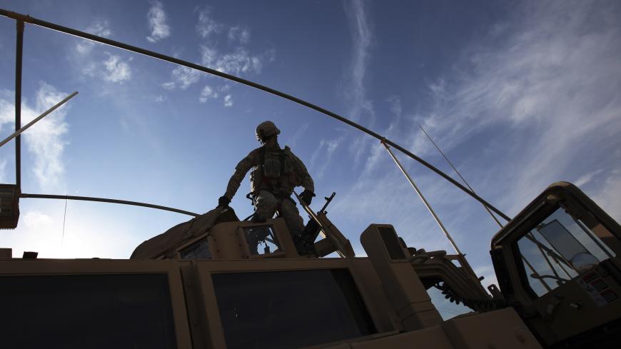 A U.S. Army soldier from the 2nd Brigade 82nd Airborne Division gets out of his Mine Resistant Ambush Protected (MRAP) vehicle after arriving at Camp Kalsu near Hillla, December 5, 2011. The brigade arrived from Taji, which is 20 miles (32 km) north of Baghdad on route to withdrawal from Iraq. REUTERS/Shannon Stapleton (IRAQ - Tags: MILITARY CONFLICT) - GM1E7C60FJF01