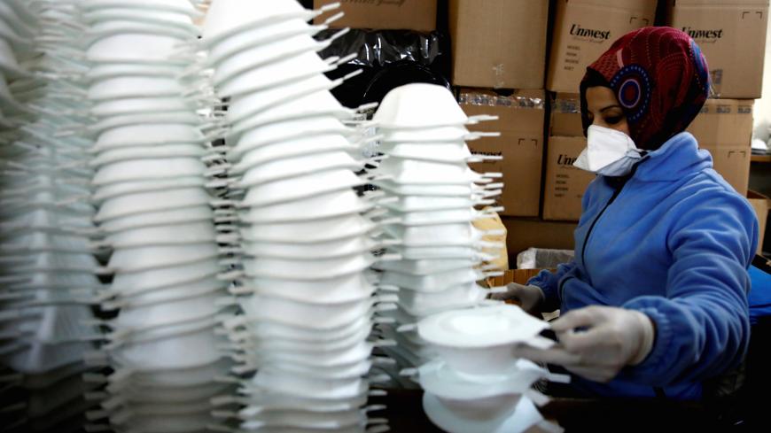 Workers produce face masks as the demand for their production rapidly increased and struggles to meet orders, at a Turkish manufacturer's facility in Istanbul, Turkey, January 30, 2020. REUTERS/Umit Bektas - RC2EQE95VNW7