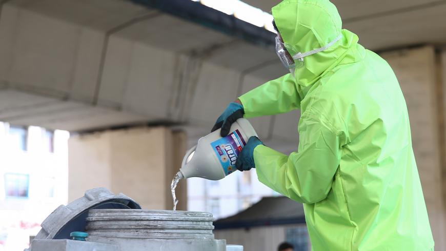A member of the medical team wears a protective face mask, following the coronavirus outbreak, as he prepares disinfectant liquid to sanitise public places in Tehran, Iran March 05, 2020. WANA (West Asia News Agency)/Nazanin Tabatabaee via REUTERS ATTENTION EDITORS - THIS IMAGE HAS BEEN SUPPLIED BY A THIRD PARTY. - RC2MDF9WLNEP