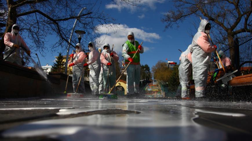 Municipality workers in protective suits disinfect Kugulu Park due to coronavirus concerns, in Ankara, Turkey, March 17, 2020. REUTERS/Cagla Durak - RC2PLF9CTCLL