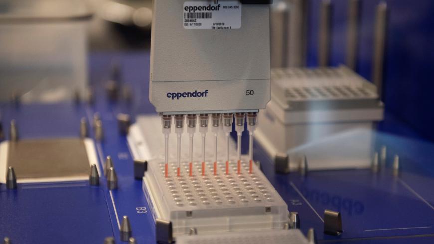 Researches at the University of Minnesota Genomics Center set up an automated liquid handler as researchers begin a trial to see whether malaria treatment hydroxychloroquine can prevent or reduce the severity of the coronavirus disease (COVID-19), at the University of Minnesota in Minneapolis, Minnesota, U.S. March 19, 2020.  REUTERS/Craig Lassig - RC2ANF97R1QI