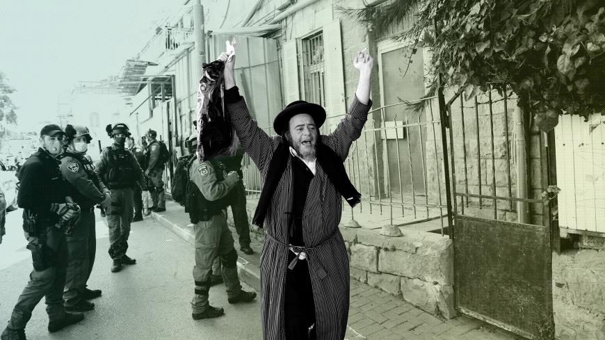 An ultra-Orthodox Jewish man reacts after police fined him for defying government restrictions set in place to curb the spread of the coronavirus disease (COVID-19), in Mea Shearim neighborhood of Jerusalem April 6, 2020. REUTERS/Ronen Zvulun - RC2YYF9YPX0X