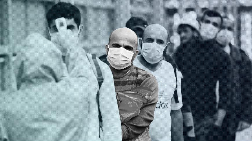 A healthcare worker checks the body temperature of Palestinian workers returning from Israel, amid concerns over the spread of the coronavirus disease (COVID-19), outside the Israeli-controlled Meitar checkpoint, near Hebron in the Israeli-occupied West Bank April 7, 2020. Picture taken April 7, 2020. REUTERS/Mussa Qawasma - RC280G9AG6MG