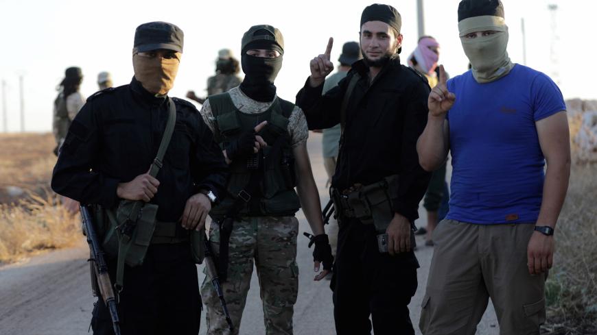 Islamist rebels from Hayat Tahrir al-Sham are seen outside the villages of al-Foua and Kefraya, Syria July 18, 2018. REUTERS/Khalil Ashawi - RC194E7A7120