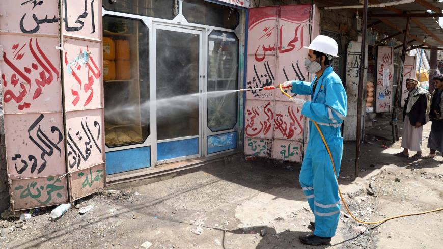 A health worker disinfects a market amid concerns of the spread of the coronavirus disease (COVID-19), on the outskirts of Sanaa, Yemen April 13, 2020. Picture taken April 13, 2020. REUTERS/Khaled Abdullah - RC2Z4G9VELS3