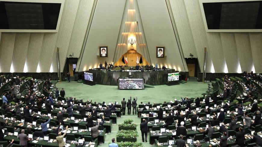 This handout picture provided by the Islamic Consultative Assembly News Agency (ICANA) on January 7, 2020 shows Iranian lawmakers raising their hands to vote during a parliamentary session in Tehran. - Iran's parliament passed a bill designating all US forces "terrorists" over the killing of a top Iranian military commander in a US strike last week. Under the newly adopted bill, all US forces and employees of the Pentagon and affiliated organisations, agents and commanders and those who ordered the "martyrd