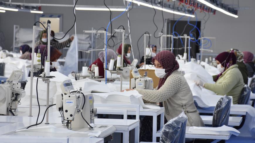 AFYONKARAHISAR, TURKEY - MARCH 31: Textile workers wearing face masks laboring at a textile factory turned into medical suits production plant due to the coronavirus (COVID-19) pandemic in Afyonkarahisar, Turkey on March 31, 2020. (Photo by Canan Tukelay/Anadolu Agency via Getty Images)